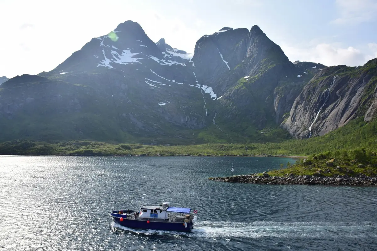 A small passenger boat in a fjord