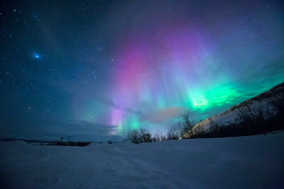 The Northern Lights over a snowy Arctic landscape